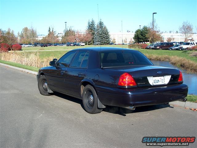 Dark blue 2001 Ford Crown Victoria sedan, rear 3/4 view, license plate ADAM-12