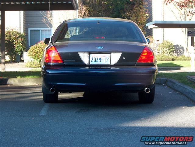 Rear view of a 2001 Ford Crown Victoria with license plate ADAM-12