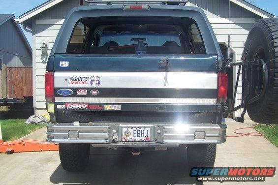 1995 Ford Bronco rear view with spare tire mount and various stickers on tailgate
