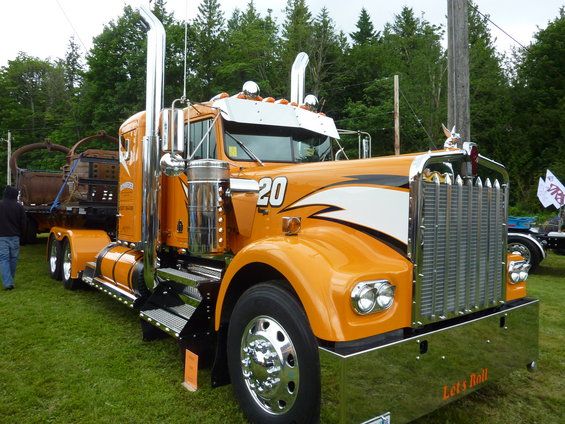 Orange semi-truck with chrome grille and exhaust stacks, number 20 on the side