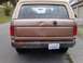 1989 Ford Bronco - Rear view of a 1989 Ford Bronco, a dented tailgate and a custom bumper.