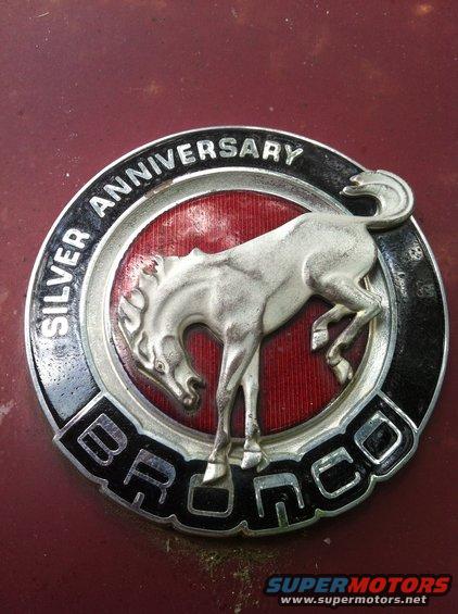 Bronco Silver Anniversary badge on red surface