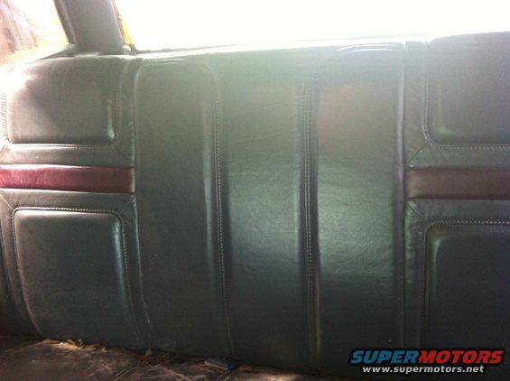 Dark colored rear car seat with burgundy stripe detail