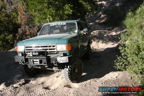 Green 1991 Ford Bronco on a dirt trail