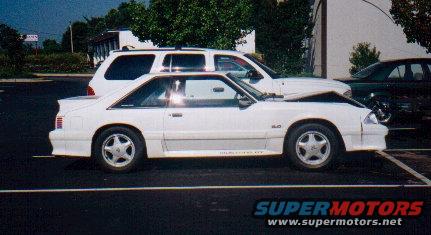 White 1987 Ford Mustang GT coupe, side view, hood open, parked in lot