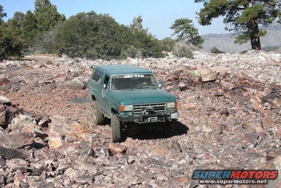 Green 1991 Ford Bronco on rocky trail