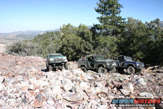 Dark green 1978 Ford Bronco and blue 1978 Ford Bronco on rocky trail