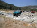 1986 Ford Bronco - Suzuki Samurai off-roading adventure with multiple vehicles present in a rocky, outdoor environment.