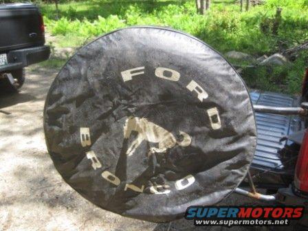 Black Ford Bronco spare tire cover with white lettering and a horse graphic
