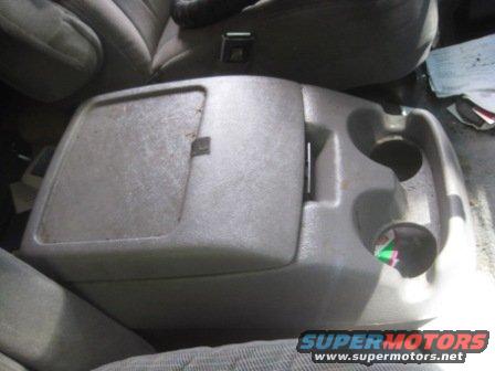 Gray plastic center console with storage compartment and cup holders