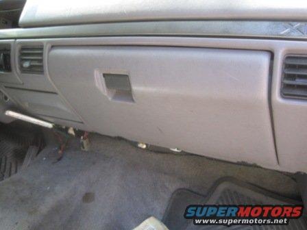 Glove box and dashboard interior of a vehicle. No year visible