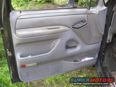 Interior of a truck door with power window controls and storage pockets