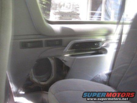 1993 Ford Bronco interior door panel with speaker cutout and light grey upholstery
