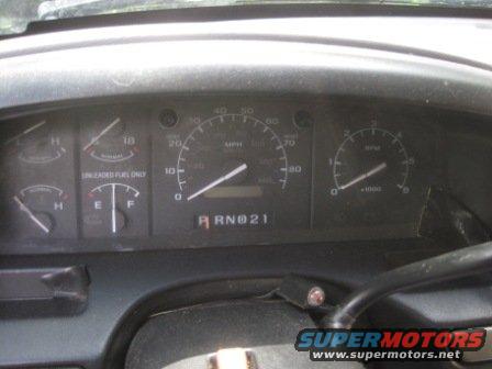 Dashboard gauges with fuel and temperature indicators, speedometer, and tachometer