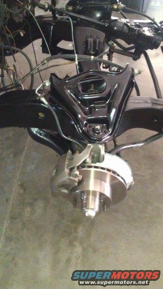 Front suspension crossmember, control arms, and disc brake assembly with caliper