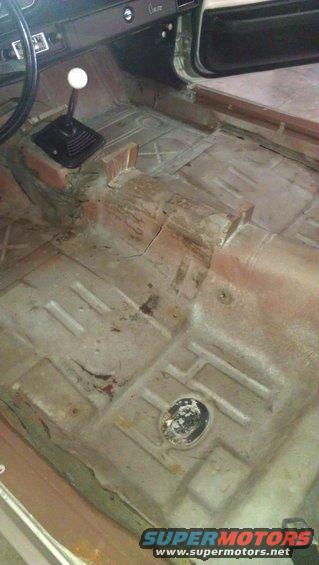 Interior of a 1973 Chevrolet Camaro showing the manual shifter and floor pan