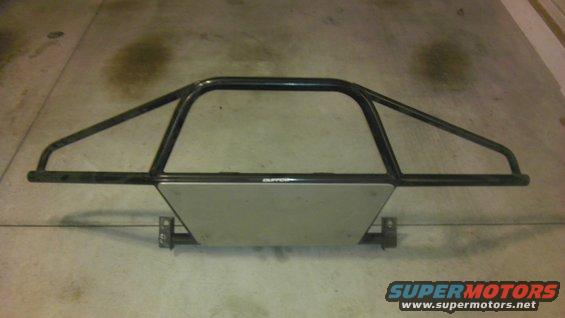 Off-road bumper with a metal skid plate and black tubing. Text on skid plate reads 'SUPERMOTORS'