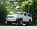1993 Ford Bronco - 1993 Ford Bronco exterior shot, showing the front three-quarter view with trees in the background.