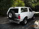 1993 Ford Bronco - This white Ford Bronco is seen from the rear 3/4 angle, with a spare tire mounted externally.
