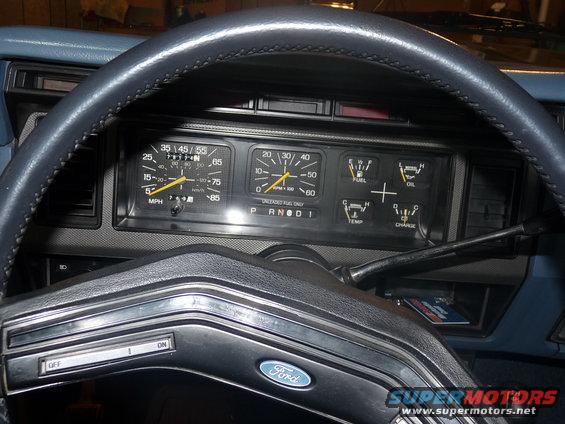 1986 Ford Bronco interior dashboard with speedometer, tachometer, fuel, oil, temp, and charge gauges