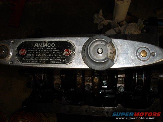 AMMMCO tension indicator torque wrench with dial gauge over engine block components