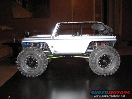 RC rock crawler with large tires and exposed suspension, side view