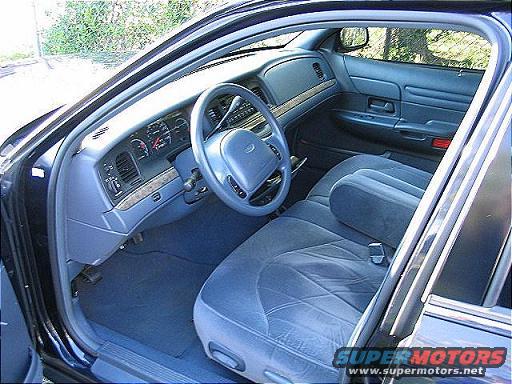 Interior of a 1999 Ford Crown Victoria showing the dashboard, steering wheel, and front seats