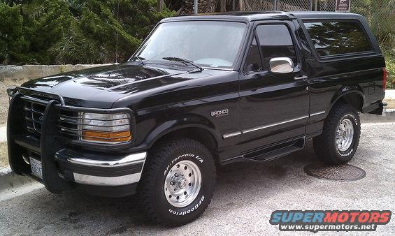 Black Ford Bronco parked on pavement, front bull bar, chrome trim, BFGoodrich tires