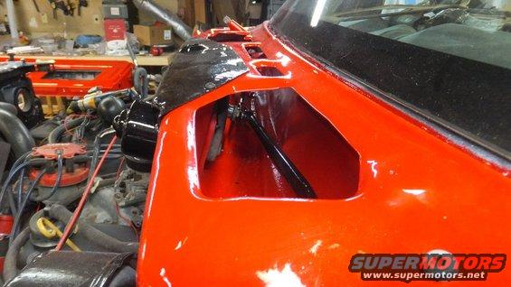 Orange vehicle fender with exposed engine and interior. Supermotors.net logo visible