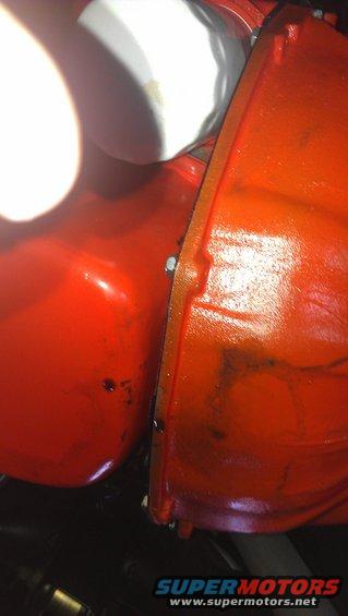 Orange engine block and oil filter with visible bolts and seams