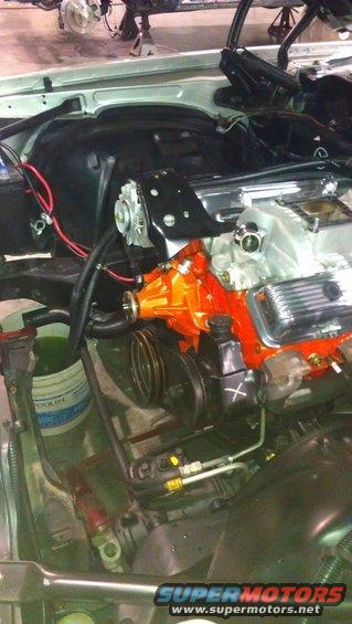 Engine bay with orange V8 engine and chrome details