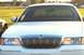 2001 Mercury Grand Marquis - Front view of a white 2001 Mercury Grand Marquis, a chrome grille and aftermarket LED strip headlights.