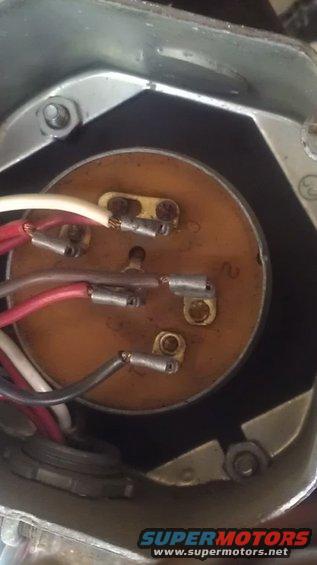 Electrical connector with wires and a visible number '2' on a wooden disc