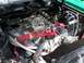1971 Ford Ranchero - Close-up view of a V8 engine bay an Edelbrock carburetor and bright red spark plug wires.