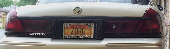 Rear of a 2000 Mercury Grand Marquis with a Kansas license plate that reads ZORG