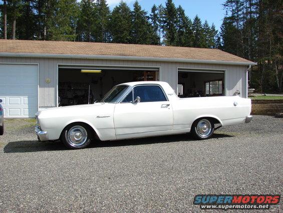 White 1966 Ford Ranchero side view parked in front of a garage