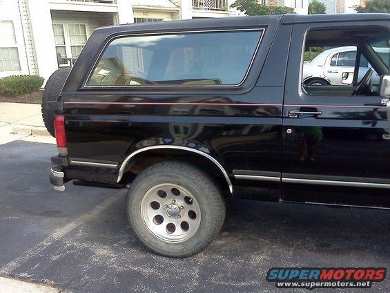Black 1990 Ford Bronco side view with spare tire mounted on the rear door