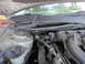 2003 Ford Taurus - Close-up view of a car's engine compartment, showing various hoses, electrical connectors, and engine components.