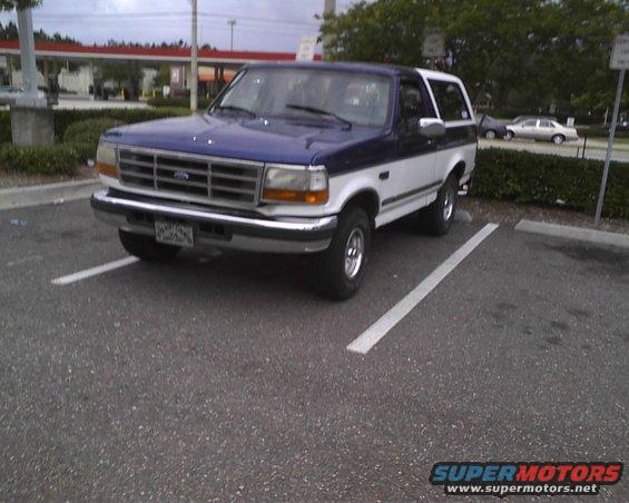 Blue and white 1996 Ford Bronco parked in a lot, 3q-front view