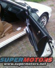 Car door open, showing interior and part of the exterior. Super Motors logo visible