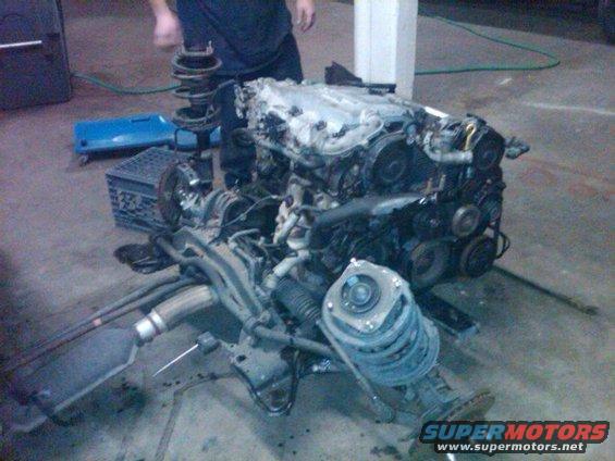 Engine assembly with exhaust and suspension parts on the floor