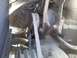 1959 Kenworth W900A - A close-up view of a dusty engine belt and pulley system, showing mechanical components and cobwebs.