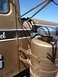 1959 Kenworth W900A - A damaged brown truck cab is seen from the side, with a large fuel tank mounted externally.