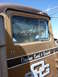 1959 Kenworth W900A - Side view of a brown truck cab with 'Owyhee Sand & Gravel' painted on the door.