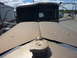1959 Kenworth W900A - View from the hood of a truck, looking towards the split windshield and a parked trailer.