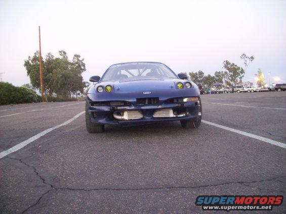 Front view of a blue 1995 Ford Probe with yellow headlights and exposed intercoolers