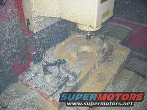 CNC machine cutting metal, lots of shavings and coolant
