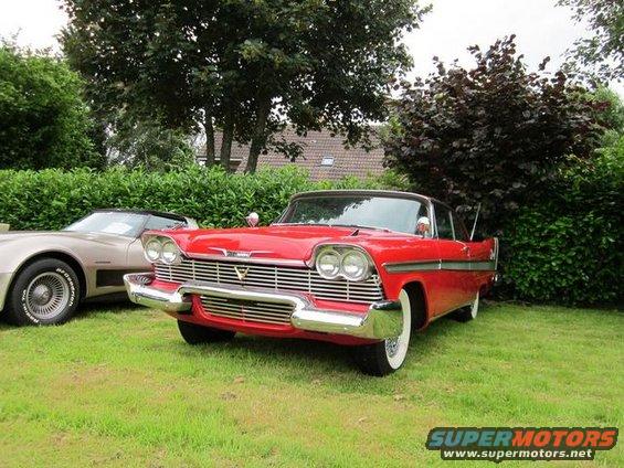Red 1957 Plymouth Belvedere 2-door hardtop with chrome grille and whitewall tires
