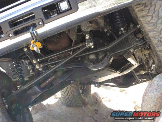 Undercarriage view of a vehicle with a winch and off-road suspension components