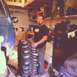 1983 Chevrolet C/K Pickup - Man with large tires in a workshop setting.